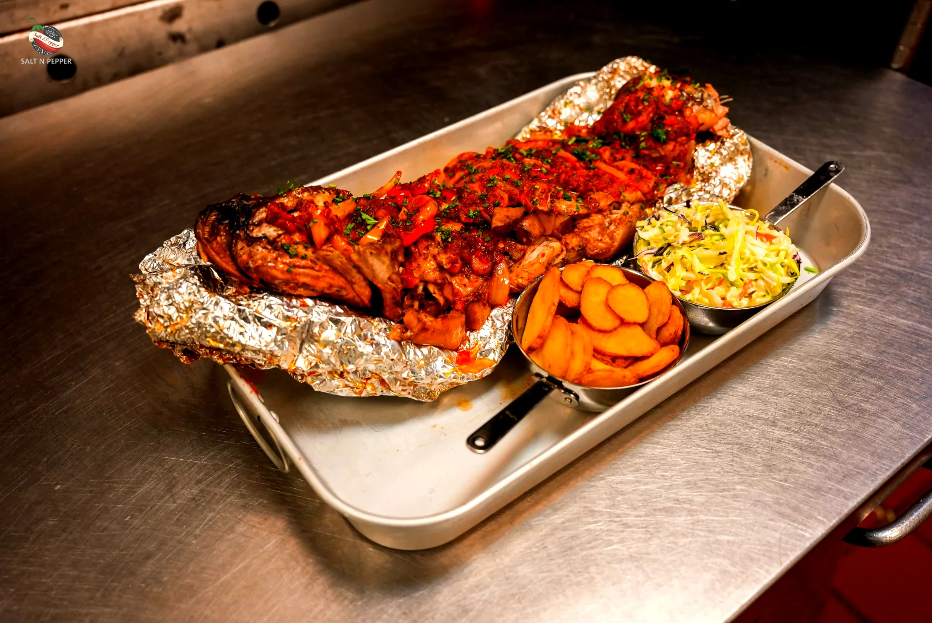 Catering tray of grilled fish with fried plantain and coleslaw