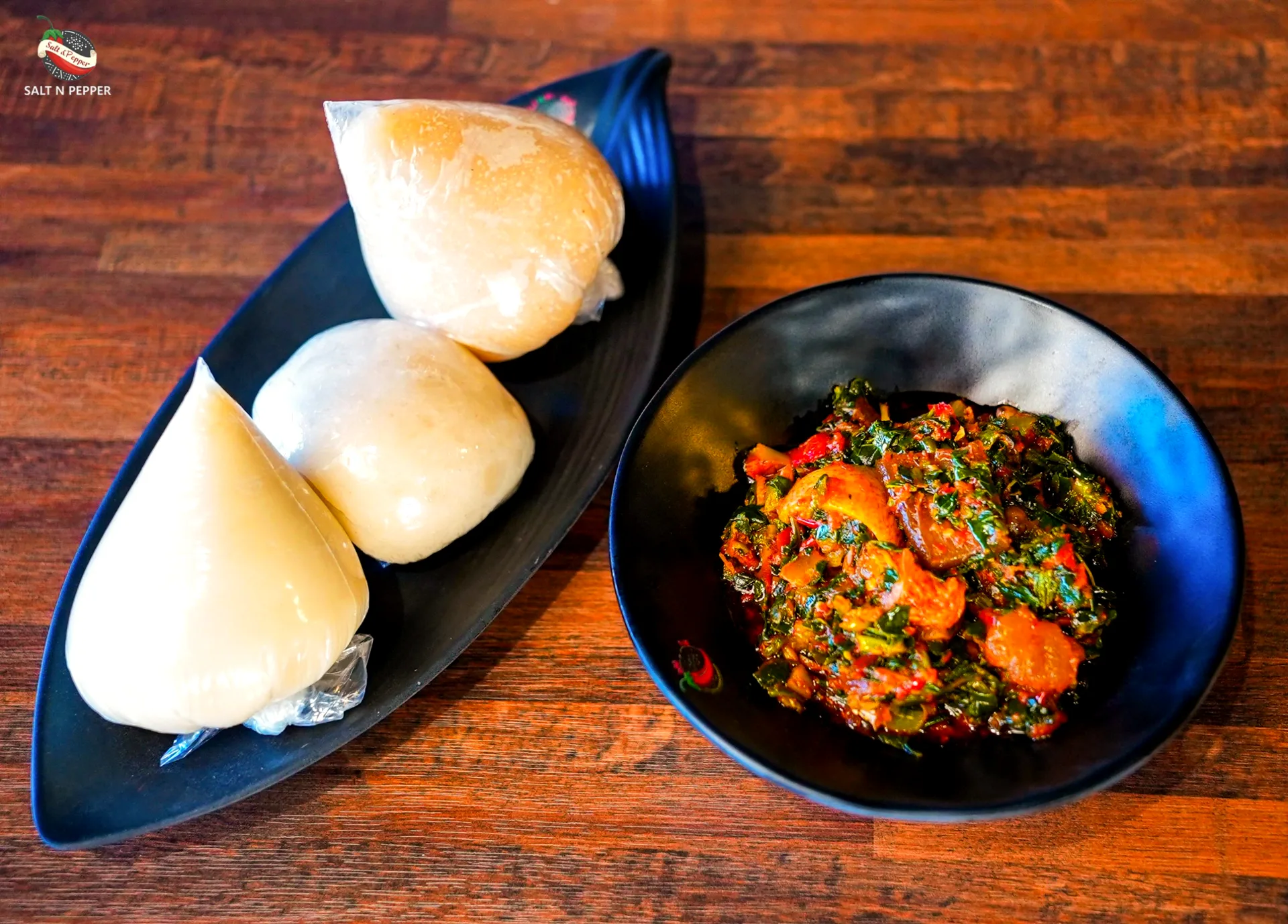 Pounded yam with vegetable soup and assorted meat